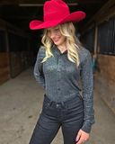 Woman wearing a red cowboy hat and dark outfit in an indoor setting