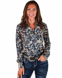Woman wearing a patterned long-sleeve shirt and jeans on a white background