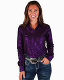 Woman wearing a purple glitter shirt and jeans on a white background