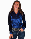 Woman wearing a blue satin shirt with velvet mesh sleeves and jeans on a white background