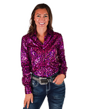 Woman wearing a pink iridescent shirt and jeans on a white background