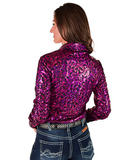 Woman wearing a pink patterned shirt and jeans on a white background