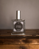 Soñora Perfume displayed on a wooden table.
