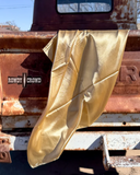 The Wynonna Wild Rag draped  across the back hatch of an old truck.