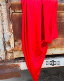 The Wynonna Wild Rag in Cherry Red draped  across the back hatch of an old truck.