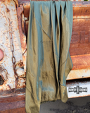 The Wynonna Wild Rag in Olive draped on the back of an old trucks hatch.