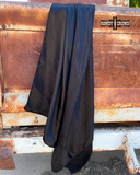 The Wynonna Wild Rag in Black draped over the back of an old truck hatch.