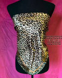 The Liberty Leopard Wild Rag displayed on a mannequin to look like a shirt in a pink background. 