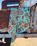 The Taos Valley Wild Rag draped over the back of an old pick up truck.
