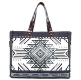 The Black Sands Weekender Bag in a  white backdrop.