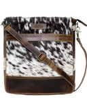 The The Salt Creek Hair on Hide Crossbody Bag in a white backdrop.