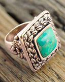 Turquoise ring on wood