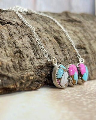 Necklace with colorful pendant on a wooden surface