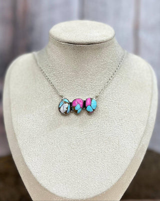 Necklace with colorful beads on a mannequin bust against a neutral background