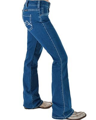 A side profile view of a person wearing blue denim flare jeans with white contrast stitching and western-style shoes, shown against a plain white background.