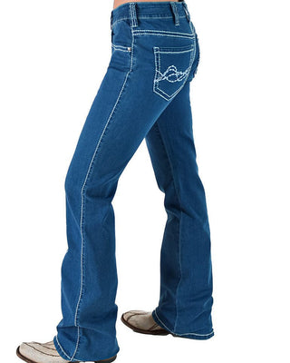 A person wearing blue denim jeans with a flared leg and white contrast stitching, shown from the waist down against a plain white background.
