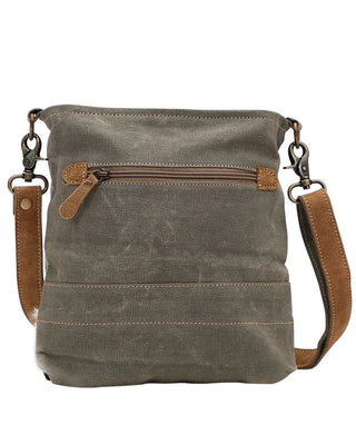 Brown leather crossbody bag with a strap on a white background
