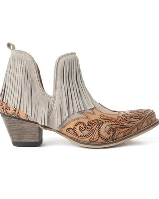 Pair of cowboy boots with fringe and intricate leatherwork on a white background