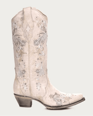 A single light beige western cowboy boot with intricate silver and white floral embroidery and rhinestone embellishments, shown against a solid light gray background.
