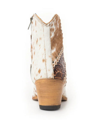 A single women's western boot shown from the back on a white background, featuring a white and brown cowhide shaft, a brown embroidered pattern panel, and a light tan stacked block heel.
