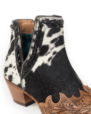Black and white cowhide leather boot with brown heel and decorative sole on a white background