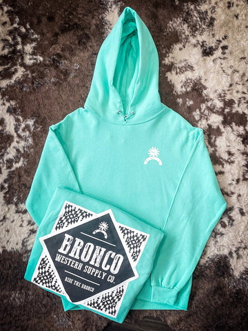 Bright teal Bronco hoodie with chest logo and folded view showing bold back graphic