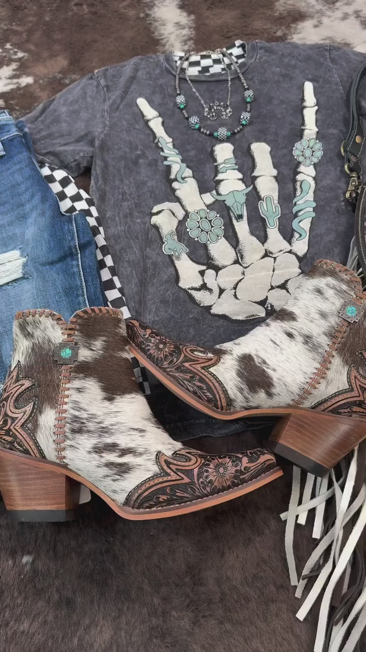 This is THE y’allternative look.

• Margie Booties: edgy + cowgirl core
• Rodesiler Jeans: your go-to flare
• Skeleton Rock Hand Tee: western with attitude

You've been needing some outfit inspo, here ya go babe 😘