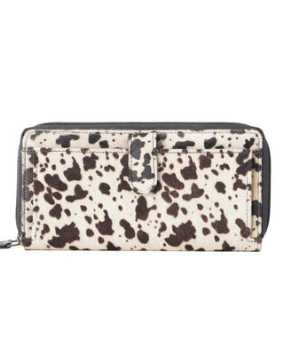 Wallet with cow print pattern on a white background
