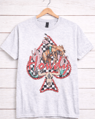 White t-shirt with colorful graphic design on a wooden background