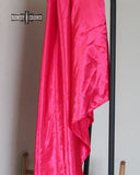 The Wynonna Wild Rag tied to a metal rack in a white background. 