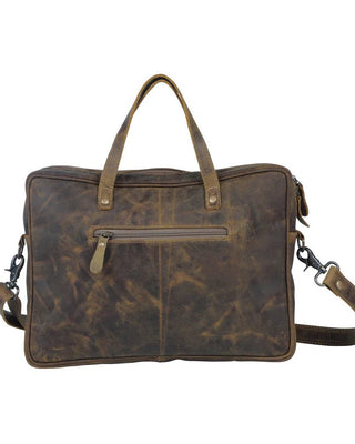 Brown leather bag with shoulder strap on a white background