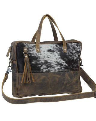 Brown leather bag with cowhide pattern on a white background