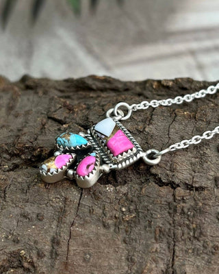 Necklace with colorful pendant on a wooden surface