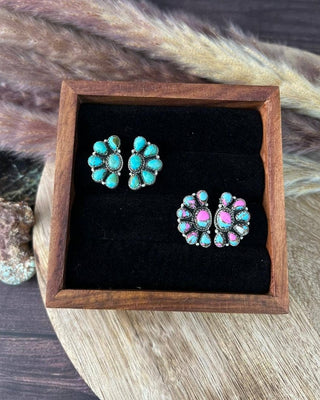 Pair of earrings in a wooden box with a natural background
