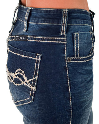 Close-up of blue jeans with 'TUFF' branding on a white background