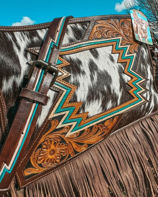 Decorative bag with intricate patterns and fringes on a blue sky background