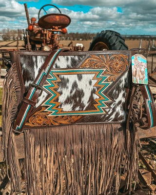 Bag with fringe and intricate design in a rustic setting