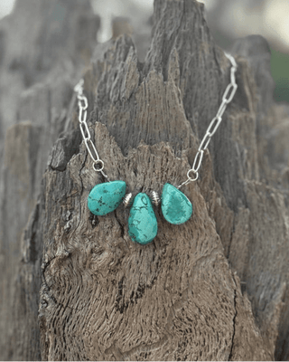 Necklace with turquoise stones on a wooden surface