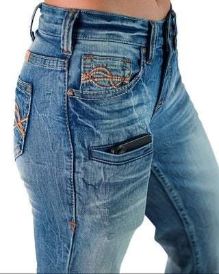 Close-up of a person wearing blue denim jeans with decorative orange-brown embroidered details on the back pockets and a black phone tucked into the front pocket, against a white background.
