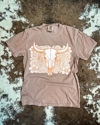 Espresso shirt with a tooled western bull skull design on a cowhide rug.