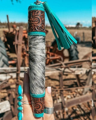 Wallet held by hand on rustic background.