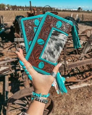 Wallet held by hand on rustic background.