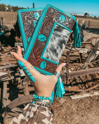 Wallet held by hand on rustic background.