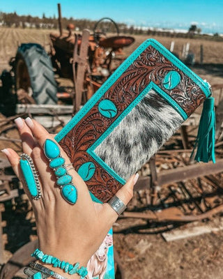 Wallet held by hand on rustic background.
