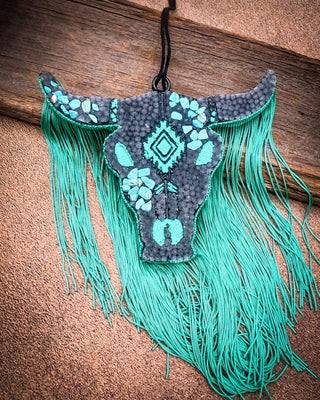 Black and Turquoise car freshie laying on wood