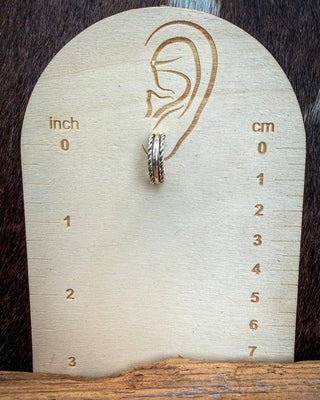Caroline Tsosie sterling silver hoop earring on an inch and centimeter size display