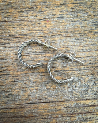 Back view of Caroline Tsosie sterling silver hoops showing open hoop shapes, posts and butterfly backs