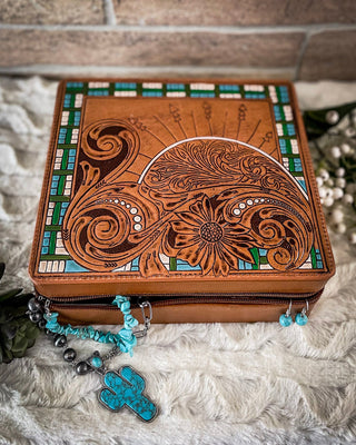 Decorative wooden box with intricate carvings on a textured surface